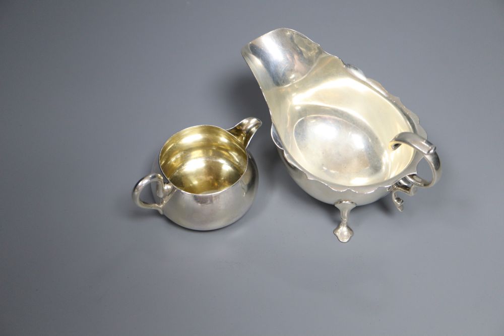 A Victorian silver cream jug, London, 1860, a later silver mustard, sauceboat and pair of pepperettes,
